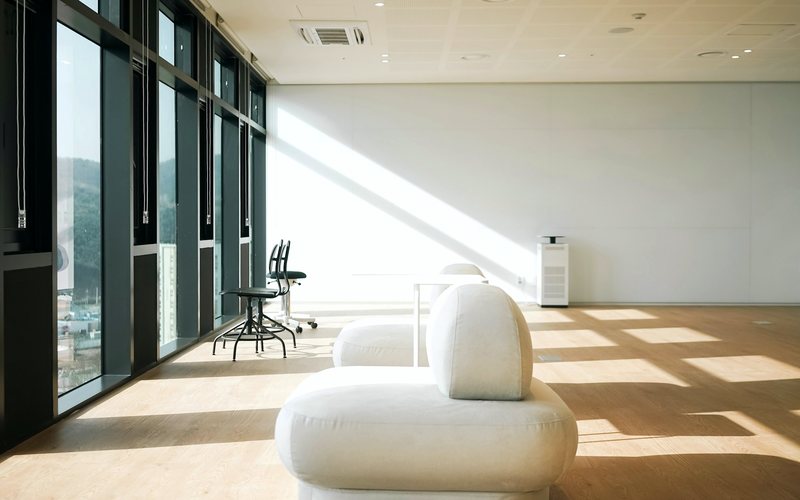 A bright modern studio interior with glass and daylight.